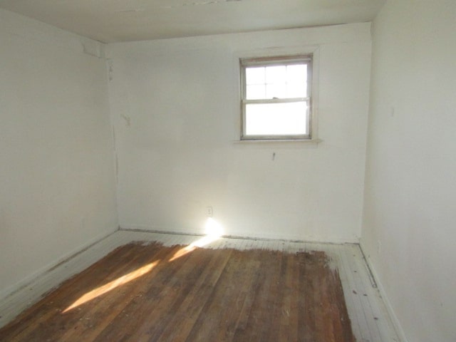 unfurnished room with dark hardwood / wood-style floors