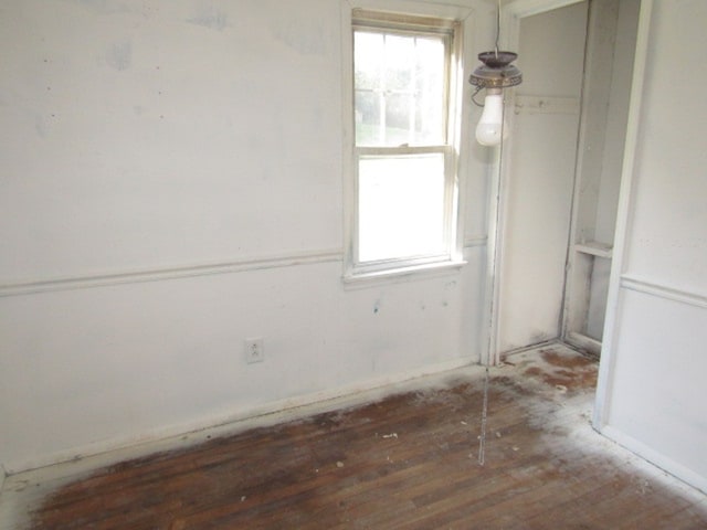 empty room with dark hardwood / wood-style flooring