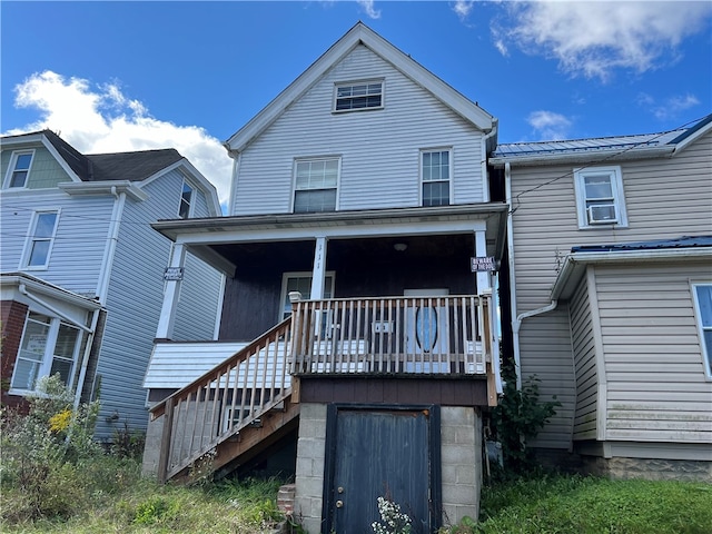 rear view of house with covered porch