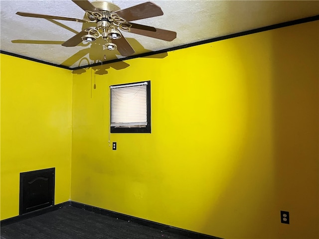 empty room with crown molding, a textured ceiling, and ceiling fan