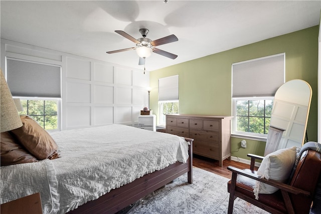 bedroom with ceiling fan and hardwood / wood-style flooring