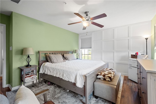 bedroom with dark hardwood / wood-style floors and ceiling fan