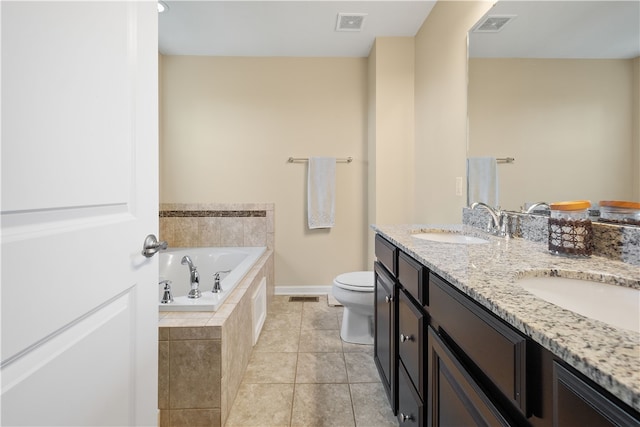 bathroom featuring toilet, a relaxing tiled tub, vanity, and tile patterned floors