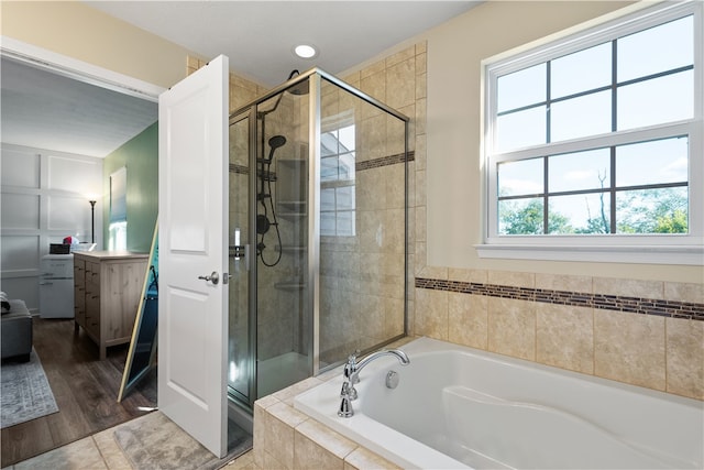 bathroom with vanity, separate shower and tub, and hardwood / wood-style flooring