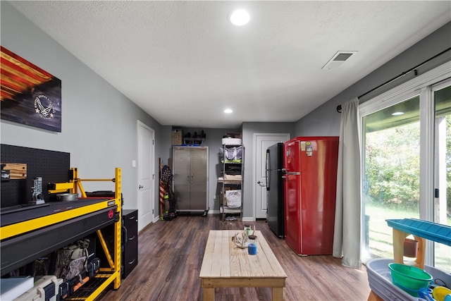 interior space with dark wood-type flooring and a textured ceiling