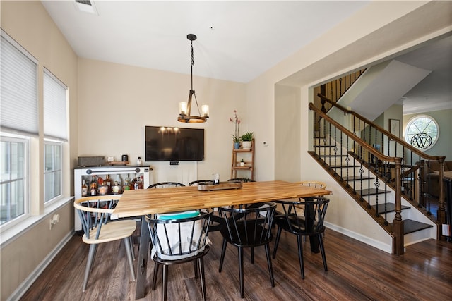 dining area featuring an inviting chandelier and dark hardwood / wood-style flooring