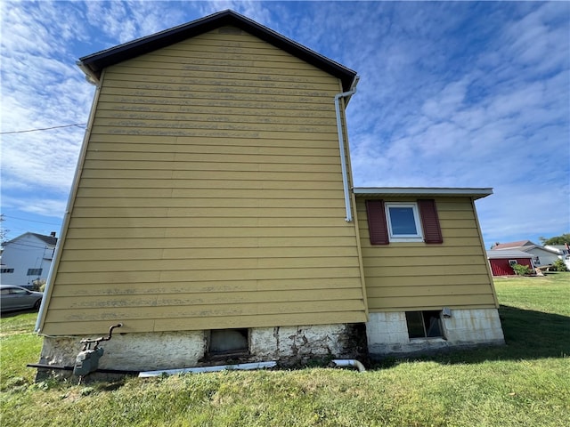 view of side of property with a lawn