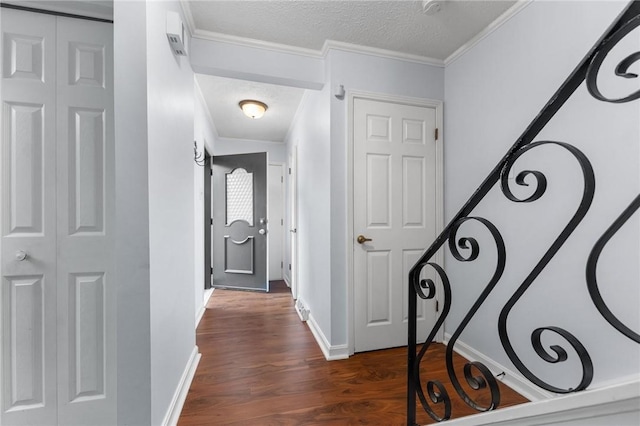 hall featuring crown molding, dark hardwood / wood-style floors, and a textured ceiling