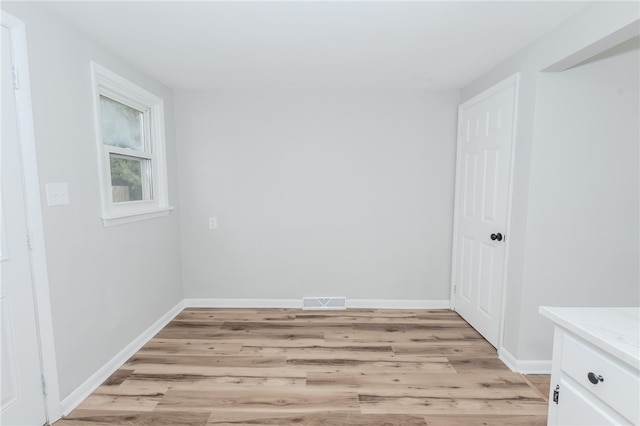 unfurnished room with light hardwood / wood-style floors