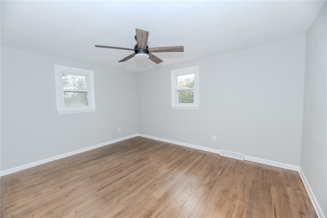 empty room featuring light wood-type flooring and ceiling fan