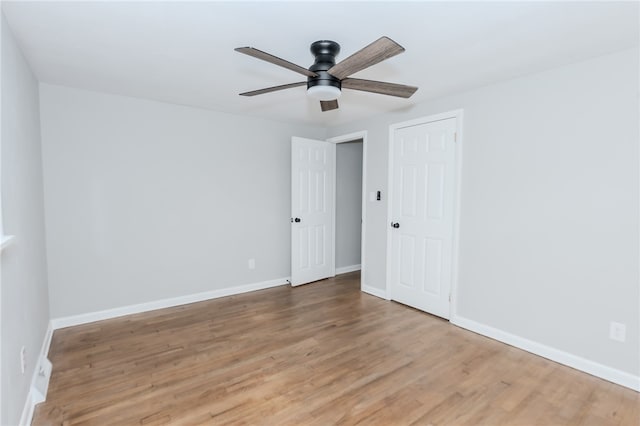 spare room featuring hardwood / wood-style floors and ceiling fan