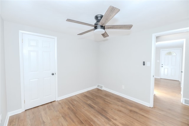 empty room featuring light hardwood / wood-style flooring and ceiling fan