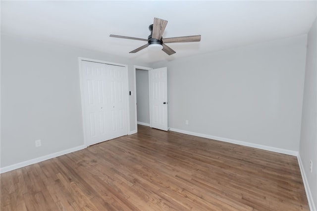 unfurnished bedroom featuring wood-type flooring, a closet, and ceiling fan