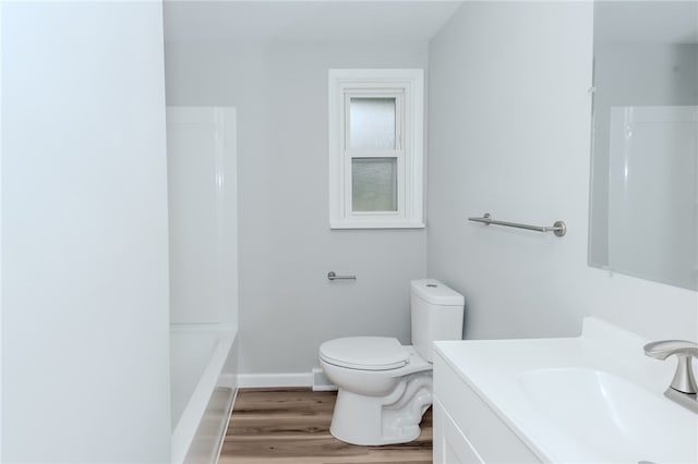 full bathroom featuring vanity, shower / washtub combination, wood-type flooring, and toilet