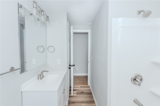 bathroom with vanity, a shower, and wood-type flooring