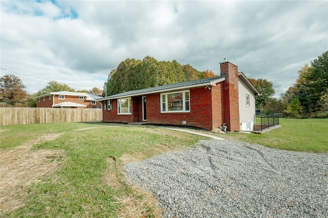 rear view of house with a yard