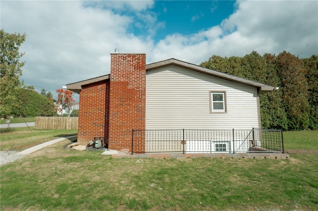 view of property exterior with a yard and a wooden deck