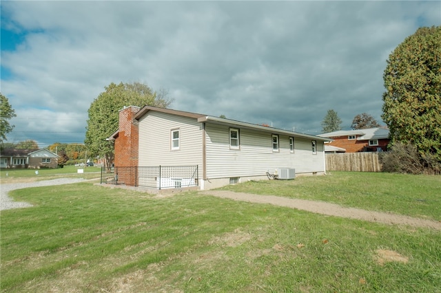 exterior space featuring a front yard and central air condition unit