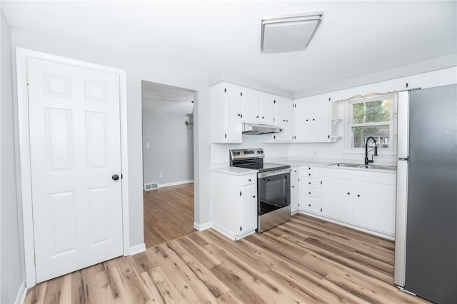 kitchen with stainless steel appliances, light wood-type flooring, and white cabinets