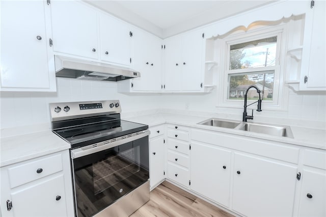 kitchen with sink, white cabinetry, electric range, and light wood-type flooring