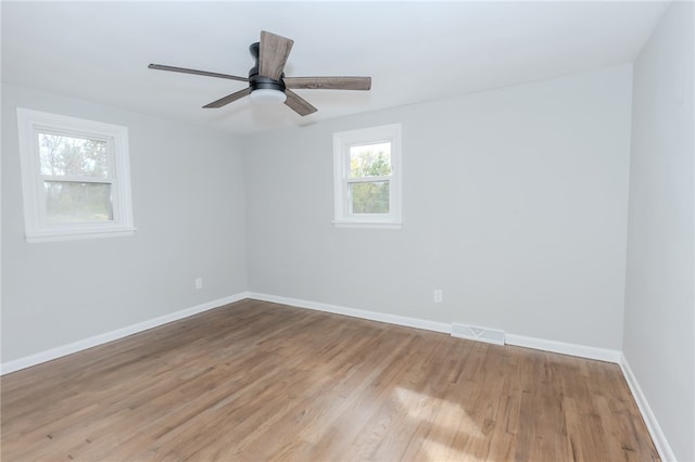 unfurnished room featuring light wood-type flooring and ceiling fan