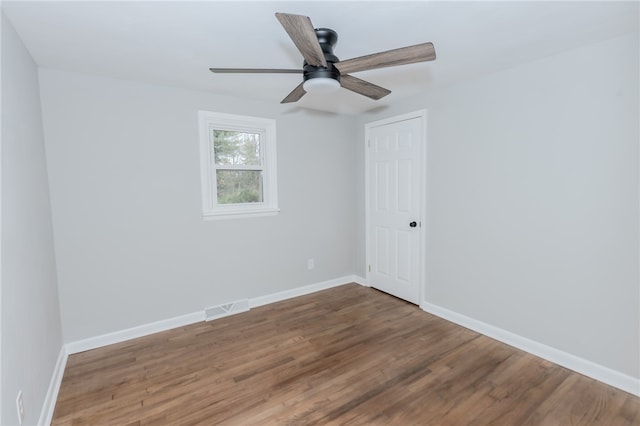 empty room with hardwood / wood-style floors and ceiling fan