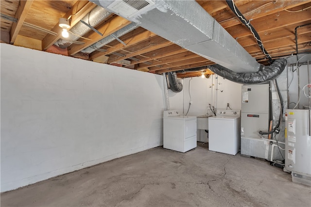 basement with washer and dryer, heating unit, and water heater