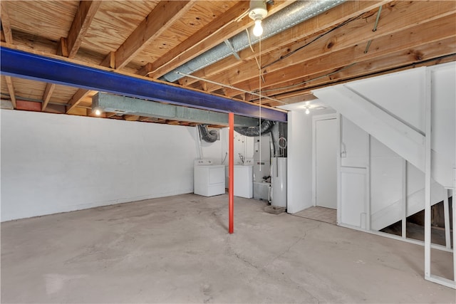 basement with water heater and washer and clothes dryer