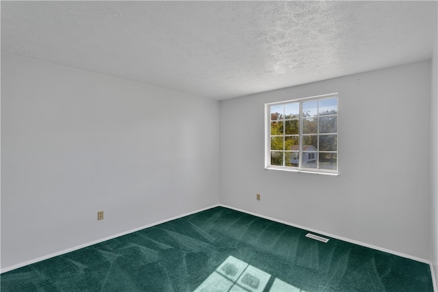 unfurnished room with a textured ceiling and carpet flooring