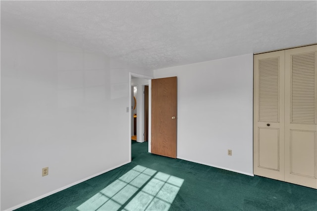 interior space with dark carpet and a textured ceiling