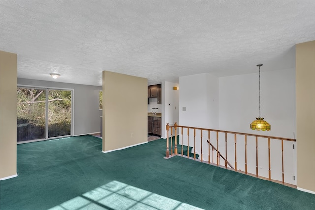 carpeted spare room with a textured ceiling