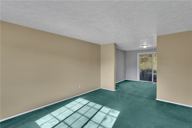 carpeted spare room with a textured ceiling