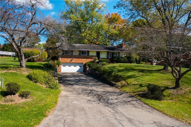 view of front of property featuring a garage and a front lawn