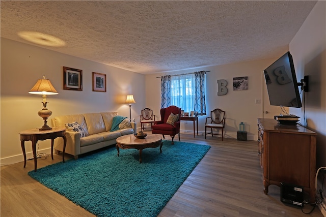 living room featuring a textured ceiling and hardwood / wood-style flooring