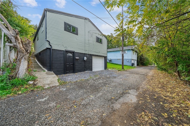 view of side of property with a garage