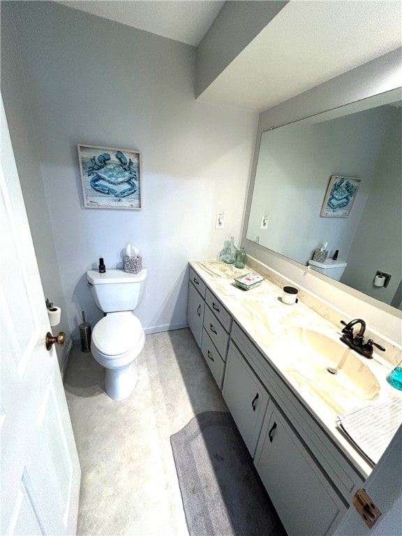 bathroom featuring toilet and vanity