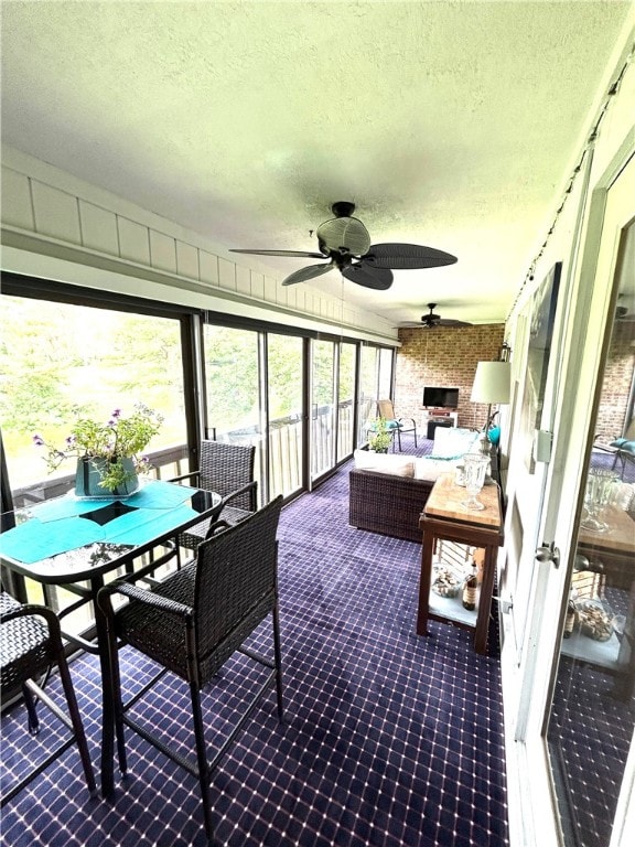 sunroom / solarium featuring ceiling fan