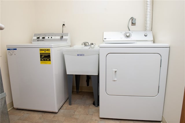 laundry room featuring sink and washing machine and clothes dryer