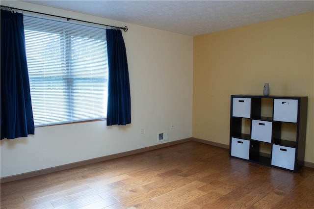 unfurnished bedroom with a textured ceiling and hardwood / wood-style flooring