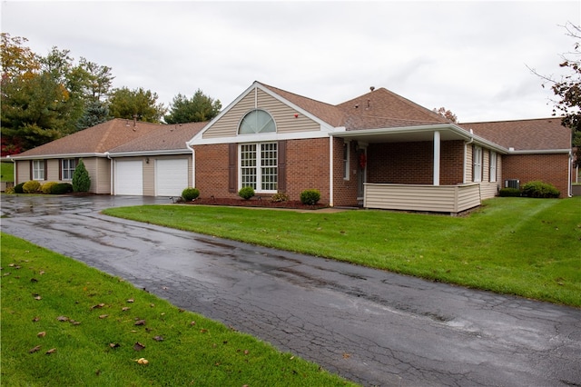 single story home with a front yard and a garage