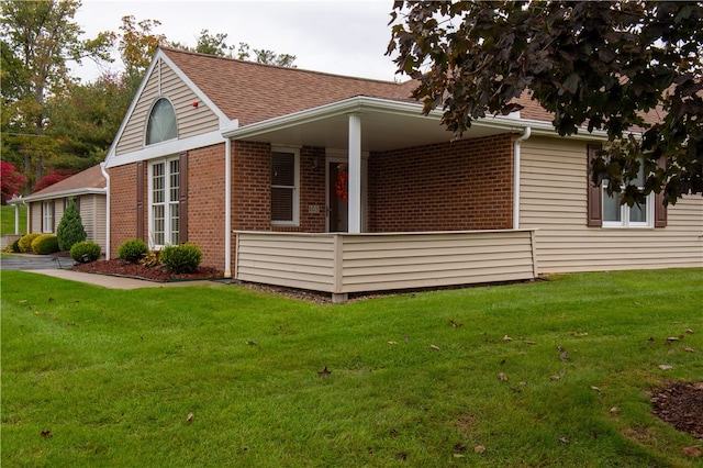 view of side of home featuring a lawn