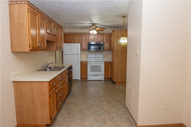 kitchen with sink, pendant lighting, appliances with stainless steel finishes, a textured ceiling, and ceiling fan