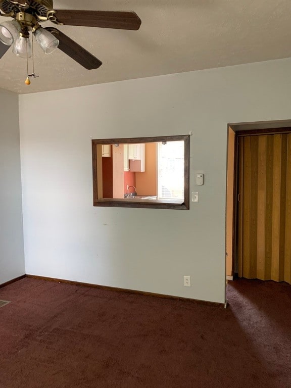 carpeted empty room with ceiling fan