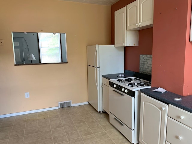 kitchen featuring white cabinets and white appliances