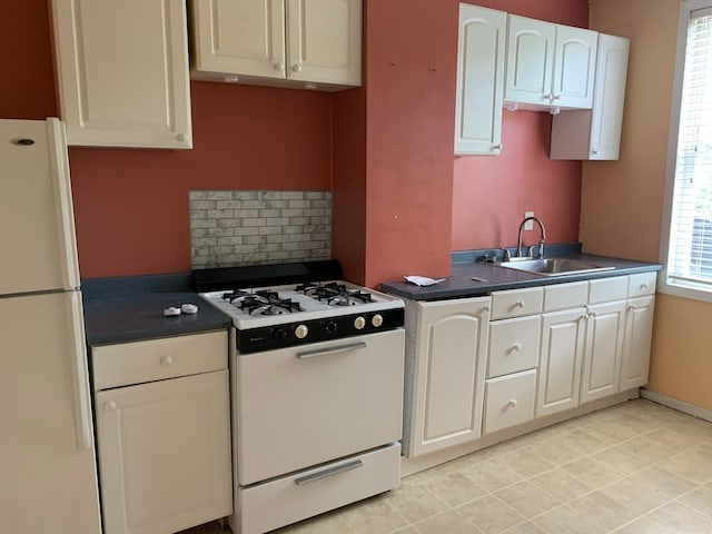 kitchen featuring decorative backsplash, sink, light tile patterned flooring, white cabinets, and white appliances