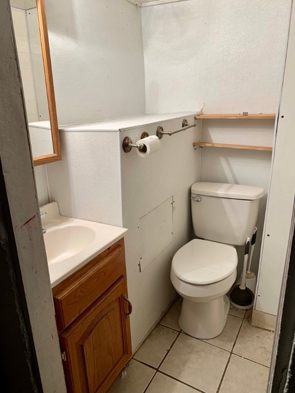 bathroom featuring vanity, toilet, and tile patterned floors