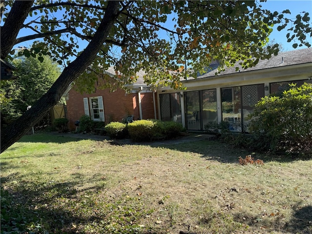 view of yard featuring a sunroom