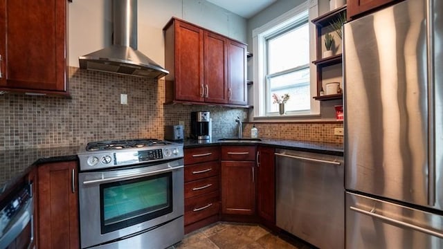 kitchen featuring wall chimney range hood, stainless steel appliances, sink, and backsplash