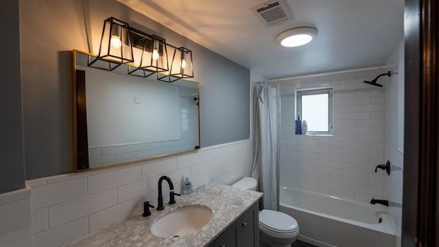 full bathroom with vanity, toilet, shower / bath combination with curtain, and tile walls