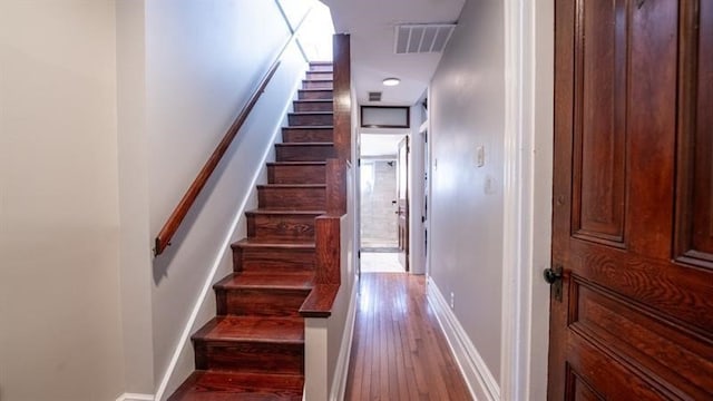 stairway with hardwood / wood-style flooring